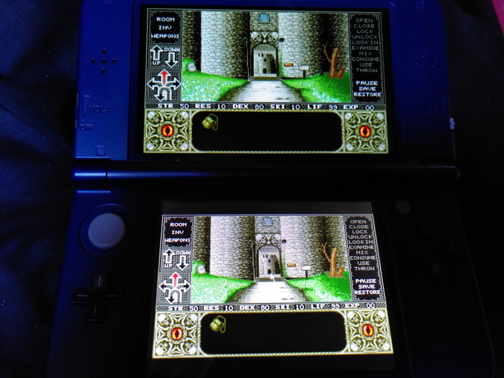 The gates of a formitable castle in a first person with navigation, inventory and interaction icons along the sides and bottom of the viewport.